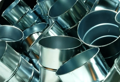 A pile of metal buckets in a warehouse.